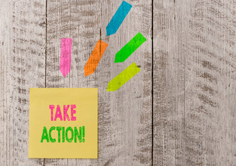 Conceptual hand writing showing Take Action. Concept meaning do something official or concerted to achieve aim with problem Note paper and line arrow stickers on the top of wooden table desk