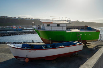 Fototapeta premium fishing boats on ground for painting in the Azores, Portugal