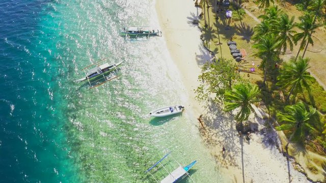Boats Moored at paradise tropical Ipil Beach on Pinagbuyutan Island with azure turquoise sea in El Nido, Palawan, Philippines