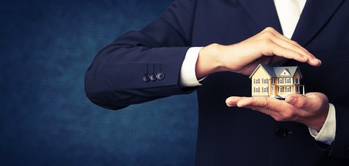 Businessman Holding House Model, Real Estate Concept