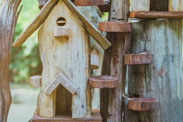 Hand made wooden bird house nest  in public Park , hand wood shelter for birds .