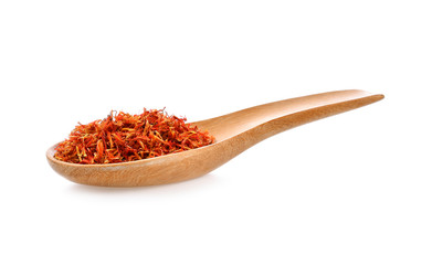 Safflower dried in wood spoon on white background
