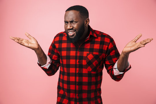 Portrait Of A Confused African Man Wearing Plaid Shirt