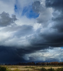 Obraz na płótnie Canvas Panorama of dramatic stormy clouds over the village