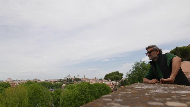Tourist watching the view at top of Giardino degli Aranci, Aventine hill, Rome, Italy