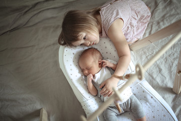 girl looks at her youngest newborn,kid hug newborn