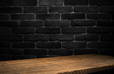 Old wooden table with brick background dark