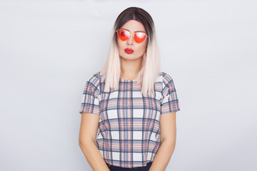 Blonde woman wearing sunglasses over white background