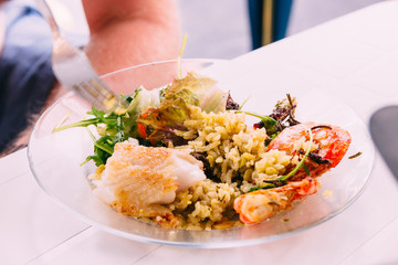 A plate with dinner and someone hold fork in hand. World health day concept.