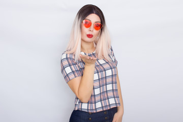 Blonde woman wearing sunglasses over white background