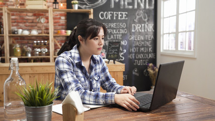 serious woman freelancer in morning coffee shop