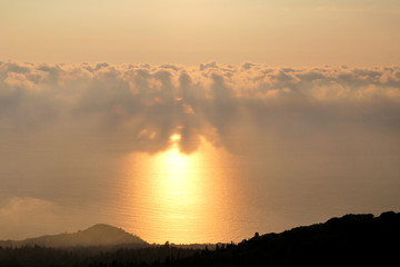 Sea, sky, beautiful structure of clouds, majestic landscape with seascape at calm sunset on horizon of mediterranean coast. Amazing sunset vibes on edge ocean. Sunrise over sea, natural environment.