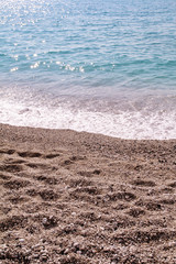 Exotic sandy beach, tropical blue mediterranean sea with waves and sea foam. Beautiful natural environment, panorama, landscape. Idyllic seaside resort in summer season, paradise and amazing scene.