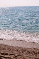 Exotic sandy beach, tropical blue mediterranean sea with waves and sea foam. Beautiful natural environment, panorama, landscape. Idyllic seaside resort in summer season, paradise and amazing scene.