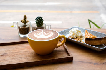 Hot latte and apple tart on a wooden table