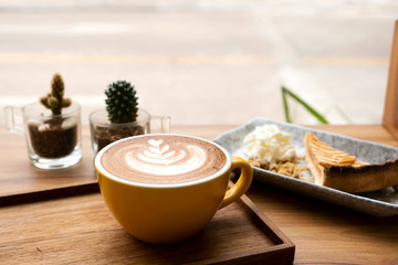 Hot latte and apple tart on a wooden table