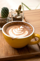 Hot latte on a wooden table
