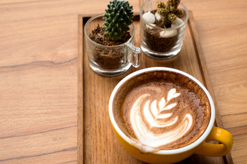 Hot latte on a wooden table