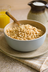 Puffed rice breakfast cereal in a wooden bowl