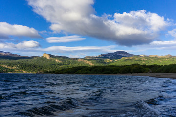 Lake shore view of Futalaufquen lake against green mountains in Los Alerces National Park, Patagonia, Argentina
