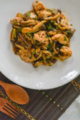 stir fried mushroom with black pepper, chicken breast, green onion on white dish. Thai delicious food. Low fat high protein and vitamins.