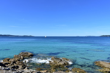 Bay with rocks, sailing boats and blue sky. Rias Baixas, Spain.