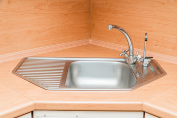 The photo of a sink in a The photo of a sink in a  kitchen