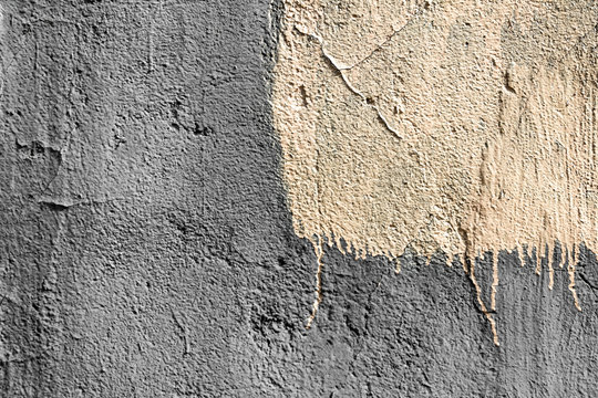 yellow square with peeling paint on gray plastered wall background. Grunge texture. copy space