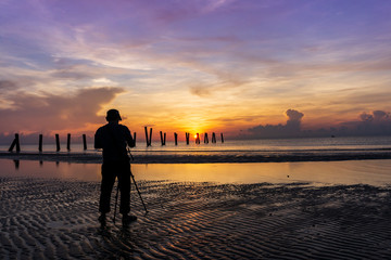 Photographers during sunrise on the beach