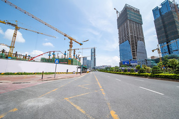 Looking up at the perspective of the city real estate new real estate construction site tower crane