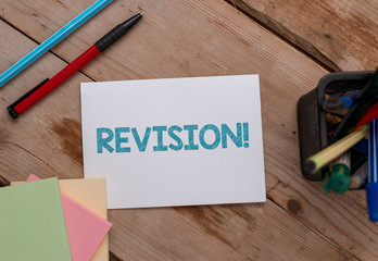 Conceptual hand writing showing Revision. Concept meaning action of revising over someone like auditing or accounting Note papers and stationary placed sideways softhued backdrop