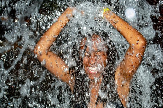 Black Woman Taking Bath From Waterfall