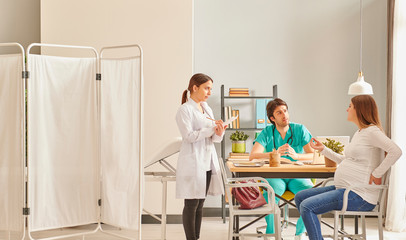 Pregnant woman is coming to doctor clinic. Baby control day in hospital.