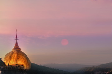 Fototapeta premium Take photo the Kyaikhtiyo Golden Rock pagoda and temple and beautiful sunshine view. This Photo contain burry and soft focus.,Selective focus.