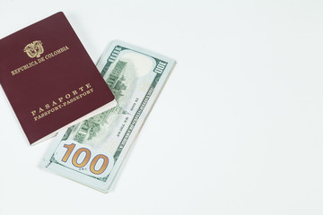 Fototapeta premium travel concept, Colombian passport with dollar bills for travel abroad
