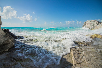 Fototapeta na wymiar Cancun beach. The caribbean sea beats against the rocks