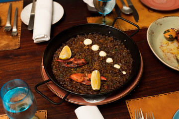 Rice Lobster prawn garlic with olive oil mix with secret recipe on plate course set of Spanish food Cuisine culinary which a bit hot and unique taste on wooden table.