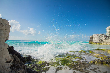 Cancun beach. The caribbean sea beats against the rocks