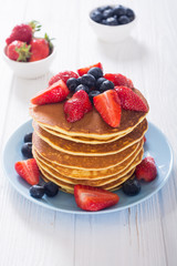 Tasty pancakes with blueberry and strawberry