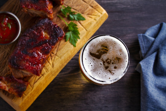 Beer and pork spare ribs. Ale and meat. Beer and food concept - Image