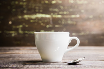 Cup of morning coffee on the rustic wooden background. Selective focus. Shallow depth of field.