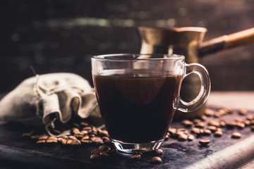 Cup of morning coffee on the rustic wooden background. Selective focus. Shallow depth of field.