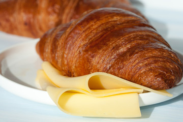 Fresh croissant with cheese.