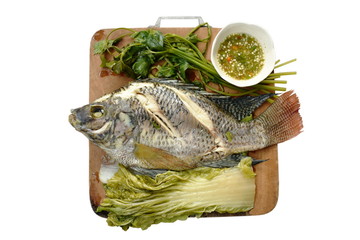 steamed mango fish with vegetable dipping spicy sauce on wooden chop block