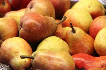 lots of red pears in the box, background. Good harvest, close-up