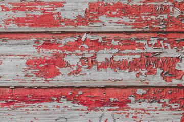 Сracked paint on wood vintage texture. Painted old wooden red wall background. Wooden grunge background