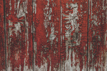 Сracked paint on wood vintage texture. Painted old wooden red wall background. Wooden grunge background