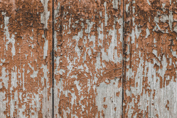 Сracked paint on wood vintage texture. Painted old wooden red wall background. Wooden grunge background