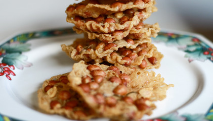 Peanut Peyek on plate. Peanut Rempeyek or Peyek is a deep-fried savoury Javanese cracker made from  rice flour with peanut by crispy flour batter. Indonesian food.