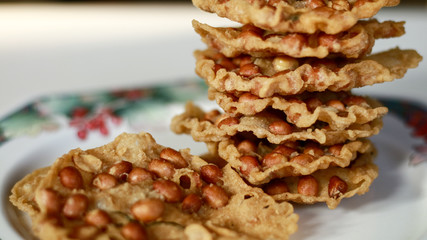 Peanut Peyek on plate. Peanut Rempeyek or Peyek is a deep-fried savoury Javanese cracker made from  rice flour with peanut by crispy flour batter. Indonesian food.